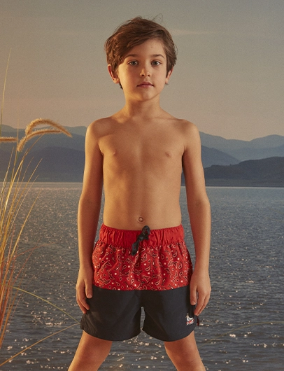 Orange swim shorts with shark print